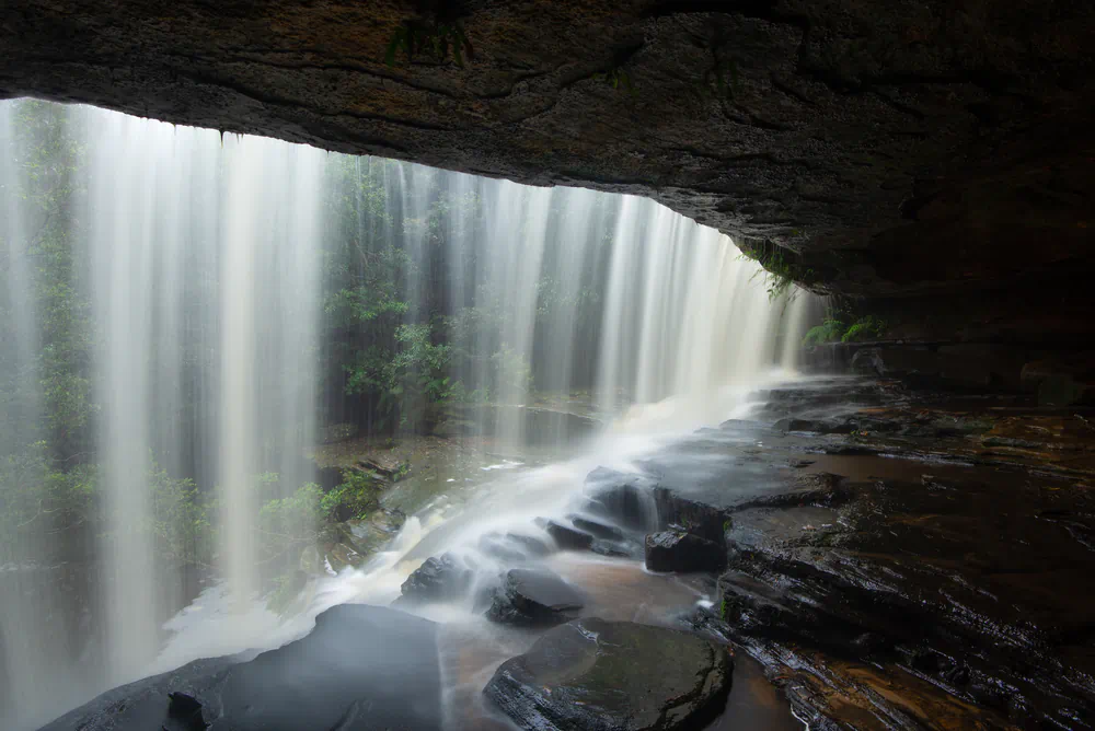 behind a waterfall